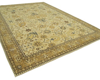 May include: A beige area rug with a floral pattern in shades of brown, beige, and blue. The rug has a decorative border with a paisley design.