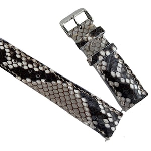 May include: A black and white snakeskin watch band with a silver buckle.
