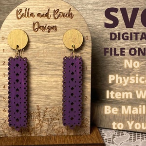 May include: A pair of purple dangle earrings with a lace design, displayed on a wooden stand. The text "SVG DIGITAL FILE ONLY No Physical Item Will Be Mailed to You." is visible in the background.
