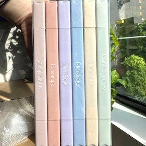 May include: Set of six pastel colored markers with dinosaur names printed on them: Ankylosaurus, Triceratops,  Diplodocus, Pterodactyl, Stegosaurus, Tyrannosaurus Rex.