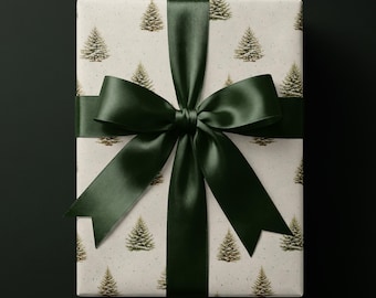May include: A rectangular gift box wrapped in off-white paper featuring a repeating pattern of small green pine trees with snowy details. The package is tied with a wide, smooth, dark forest green satin ribbon tied into a large bow.