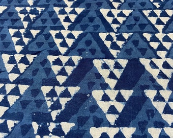 May include: Indigo blue fabric with a white geometric pattern of repeating triangles. The fabric has a textured, hand-woven look.