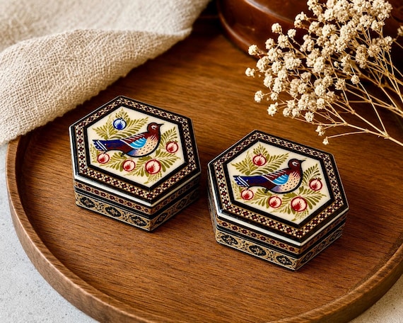 Genuine Persian Khatam inlay work — hundreds of tiny pieces of wood, bone, and metal hand-fitted into geometric mosaics — produces a jewelry box that looks like it escaped a museum gift shop in the best way.