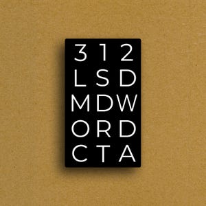 May include: A black rectangular sign with white text. The text includes the numbers "312" and the letters "LSD", "MDW", "ORD", and "CTA". The sign is set against a tan background.