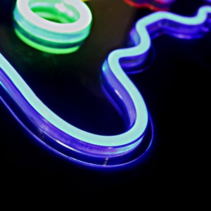 May include: A neon sign in the shape of a cloud with a blue outline and a white glow. The cloud is on a black background.