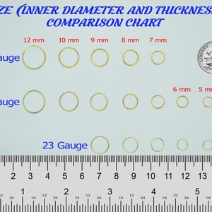 May include: A size comparison chart for jump rings. The chart shows the inner diameter and thickness of jump rings in millimeters. The chart includes jump rings in 20 gauge, 22 gauge, and 23 gauge. The jump rings are arranged in rows by gauge and then by size. The chart also includes a ruler for reference.