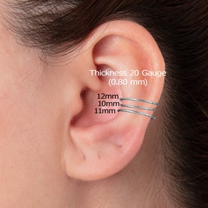 May include: Three silver ear cuffs in different sizes. The ear cuffs are 12mm, 10mm, and 11mm in diameter. The text on the image reads: 'Thickness 20 Gauge (0.80 mm)'