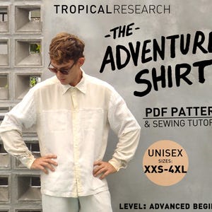 May include: Cream-colored long-sleeve shirt with the text "-THE- ADVENTURE SHIRT" and "PDF PATTERN & SEWING TUTORIAL". The shirt is available in unisex sizes XXS-4XL. The level is advanced beginner.