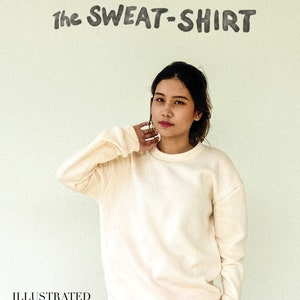 May include: A cream-coloured sweatshirt with long sleeves. The text "The SWEAT-SHIRT" is above a person. The image also includes the text "TROPICAL RESEARCH" and "ILLUSTRATED TUTORIAL pattern hacks".