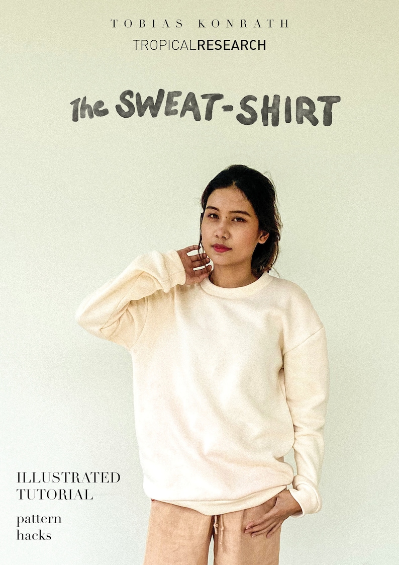 May include: A cream-coloured sweatshirt with long sleeves. The text "The SWEAT-SHIRT" is above a person. The image also includes the text "TROPICAL RESEARCH" and "ILLUSTRATED TUTORIAL pattern hacks".