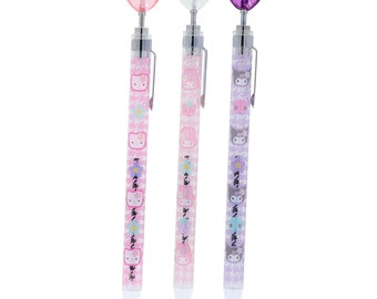 May include: Three pencils with heart-shaped toppers in pink, clear, and purple. The pencil barrels feature cartoon characters and floral patterns on a houndstooth background. Each pencil has a silver clip and a white tip.