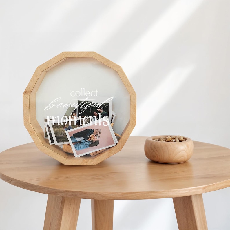 May include: A wooden photo box with a clear glass lid. The box is filled with photos and has the text "collect beautiful moments" written on the front.