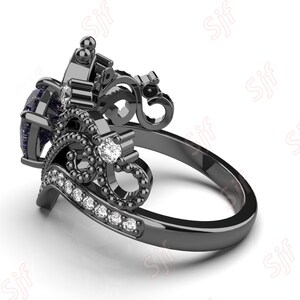 May include: Black ring with a large blue gemstone and smaller white gemstones set in a detailed, ornate design.