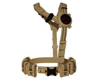 May include: Tan-colored tactical harness with a belt featuring pouches and a central buckle. The harness has a circular element with a red center and black accents. The design includes adjustable straps and multiple attachment points.