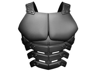 Könnte beinhalten: Eine schwarze Brustpanzerung mit strukturierter Oberfläche. Die Rüstung hat Schultergurte und ein segmentiertes Design über Brust und Bauch. Das Design deutet auf ein futuristisches oder Fantasy-Thema hin.