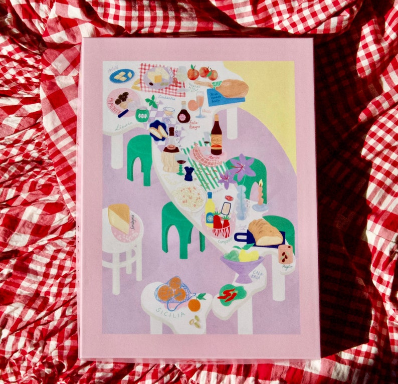 May include: A colorful illustration of a map of Italy with a table setting on top. The table is set with food, wine, and other items. The illustration is on a pink background with the words "Sicilia" and "Calabria" written on the map.