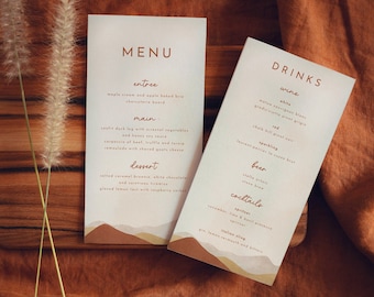 May include: A menu with a brown and orange mountain landscape design. The menu lists entree, main, dessert, wine, beer, and cocktails. The text is in a brown font.