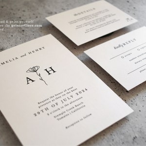May include: A white wedding invitation with black text. The invitation reads "Amelia and Henry" with a floral design and the initials "A H". The invitation details the wedding date, time, and location. A separate white RSVP card with black text reads "kindly reply".