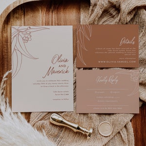 May include: Wedding invitation suite featuring a cream-colored invitation card with floral line art and the names "Olivia and Maverick." Includes details, RSVP, and a gold wax seal. The suite is displayed on a textured beige surface.
