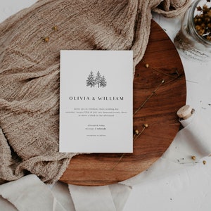 May include: A white wedding invitation with a simple black illustration of two pine trees. The text reads "Olivia & William" and includes the wedding date, time, and location: "Saturday, twenty fifth of July two thousand twenty three at three o'clock in the afternoon, Silverpick Lodge, Durango, Colorado."