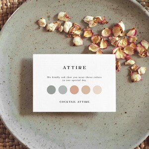May include: A white card with the word "ATTIRE" in black text. The card also includes the text "We kindly ask that you wear these colors to our special day." and "COCKTAIL ATTIRE". There are five color swatches on the card: two shades of blue, one peach, and two shades of beige.