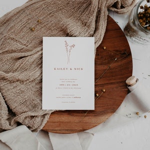 May include: A minimalist wedding invitation with a simple floral design in maroon. The invitation reads "Kaikey & Nick" and includes the wedding date "Aug 24, 2023" and the location "Terreno Resort, Rancho Palos Verdes, California".