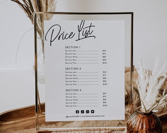 May include: A gold framed sign with a white background and black text that reads "Price List". The sign lists prices for different services, with sections labeled "Section 1", "Section 2", and "Section 2". The sign also includes social media icons and the text "@yourhandle | www.businessname.com".