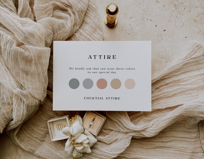 May include: A white card with the word "ATTIRE" in black text. The card says "We kindly ask that you wear these colors to our special day." and shows five color swatches: two shades of gray, one light pink, one medium pink, and one light peach. The card also says "COCKTAIL ATTIRE" in black text.