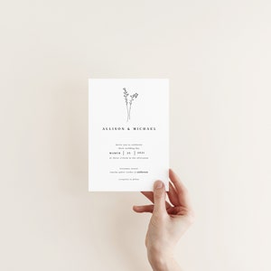 May include: A simple wedding invitation with a minimalist design featuring a small floral illustration and the text "Allison & Michael" at the top. The invitation details the date of the wedding as "March 25, 2021" and the location as "The Venue in the Afternoon".