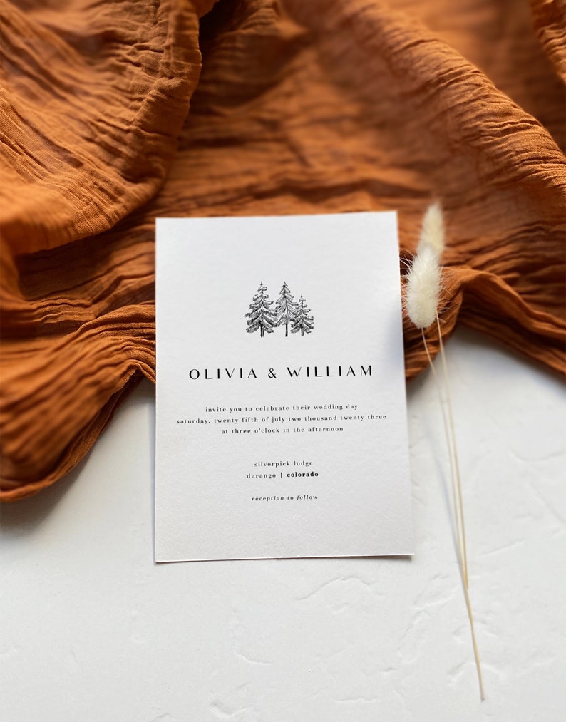 May include: A minimalist wedding invitation with a simple illustration of three pine trees. The invitation reads "Olivia & William" and includes the wedding date, time, and location: "Saturday, twenty fifth of July two thousand twenty three at three o'clock in the afternoon. Silverpick Lodge, Durango, Colorado. Reception to follow."