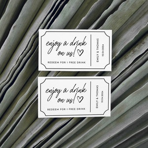 May include: Two white drink tickets with black text that reads "enjoy a drink on us!" and "REDEEM FOR 1 FREE DRINK". The tickets also include the names "EMILY & THOMAS" and the date "10.04.2024".