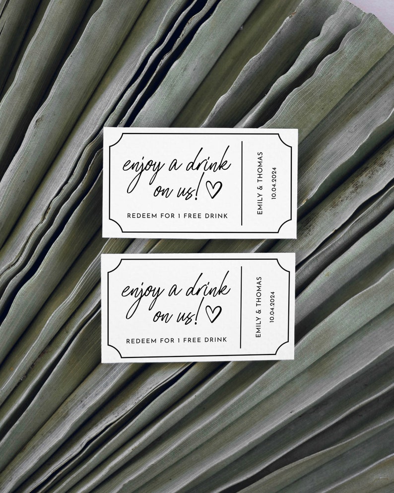 May include: Two white drink tickets with black text that reads "enjoy a drink on us!" and "REDEEM FOR 1 FREE DRINK". The tickets also include the names "EMILY & THOMAS" and the date "10.04.2024".