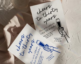 May include: Two white cards with blue text and illustrations of a hand holding a glass of champagne. The text on the cards reads "Cheers to thirty years" and includes details for a 30th birthday party.