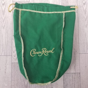May include: Green drawstring bag with a gold embroidered Crown Royal logo.