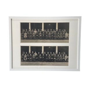 May include: A framed black and white photograph of two rows of men in suits and ties. The men are standing in front of a building with columns. The photo is titled "Merchant's Exchange" and is dated 1929.