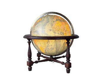 May include: A vintage illuminated globe with a detailed map, set on a dark wooden stand. The globe is encircled by a metal meridian ring and features a warm, inviting glow, showcasing geographical features.