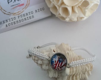 May include: White string bracelet with a silver charm featuring a colorful image of the Puerto Rican flag.