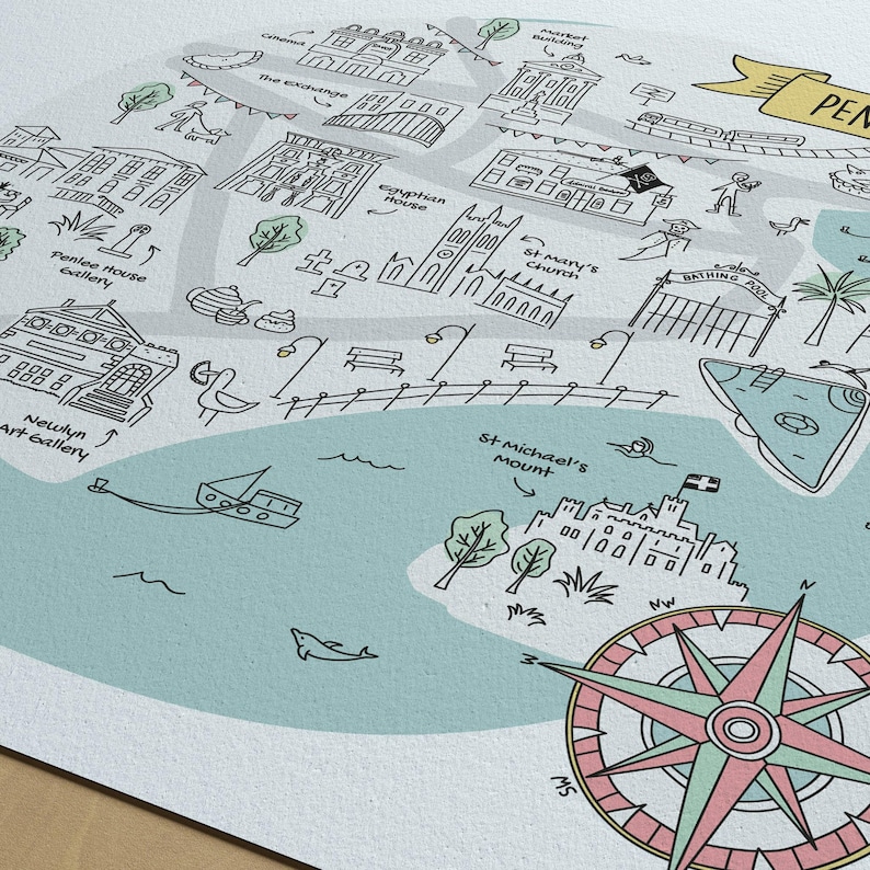 May include: A detailed illustrated map featuring black line drawings of landmarks like St. Mary's Church, Newlyn Art Gallery, and St. Michael's Mount. The map includes a compass rose, light blue water sections, and text labels for various locations.