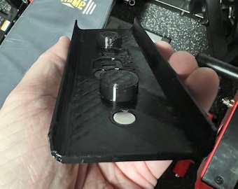 May include: Black plastic weight plate holder with two black metal knobs. The holder is designed to be attached to a weight bench.