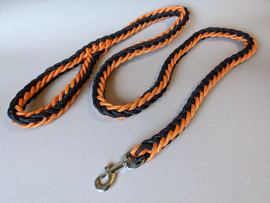 Dog leash made of orange black paracord with a fixed hand strap 1.2 m for medium and larger dogs