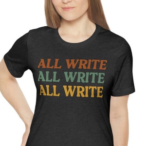 May include: A dark heather grey t-shirt with the text "ALL WRITE" repeated three times in a retro font. The text is in shades of orange, green, and yellow.