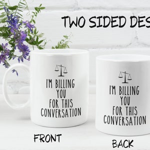 May include: White ceramic mug with a black scale design and the text "I'm billing you for this conversation" on both sides.