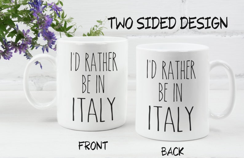 May include: White ceramic mug with black text that reads "I'd rather be in Italy" on both sides. The mug is shown on a white surface.