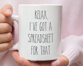 May include: White ceramic coffee mug with black text that reads "Relax, I've got a spreadsheet for that."