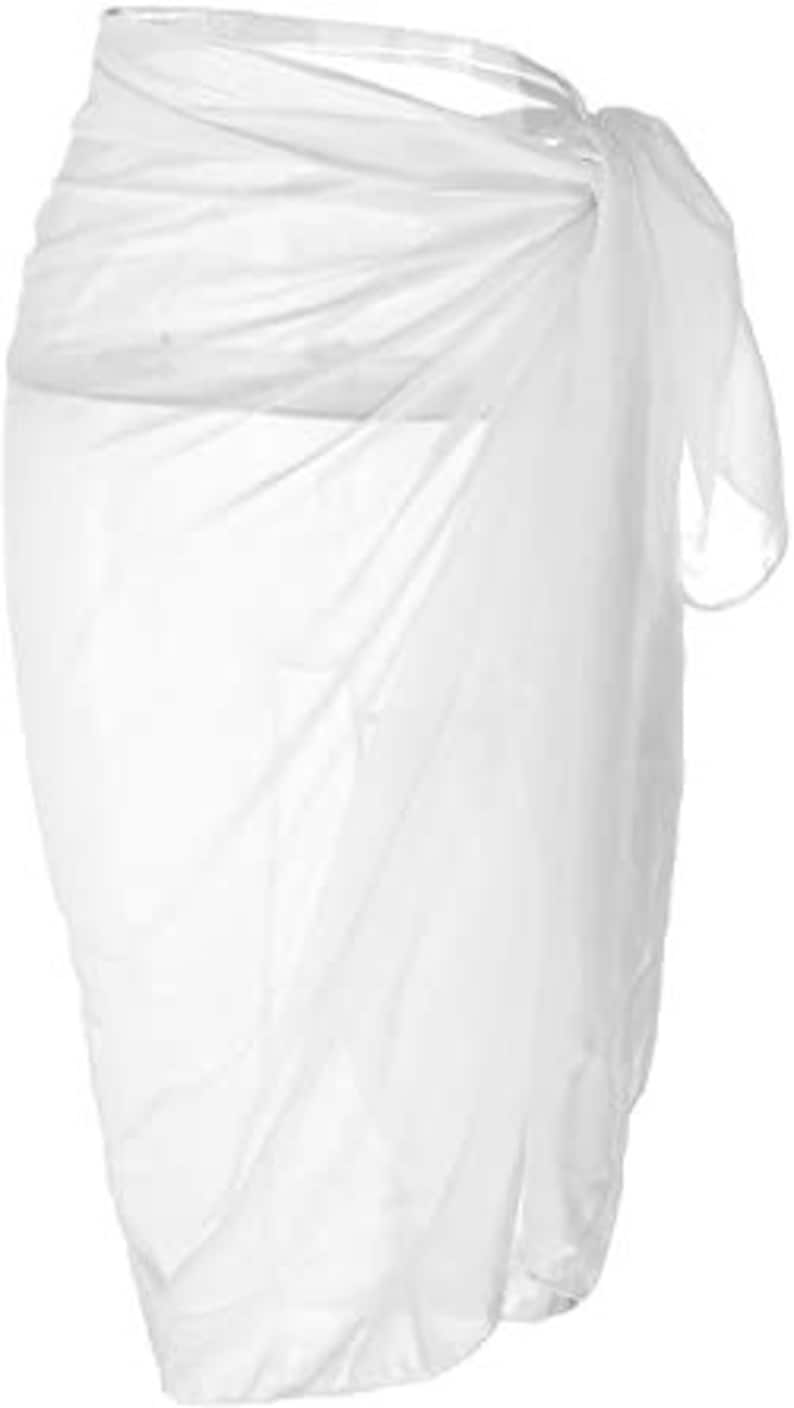 May include: White sheer sarong wrap skirt. The skirt is made of a lightweight, flowy fabric and can be worn as a beach cover-up or a casual summer skirt.