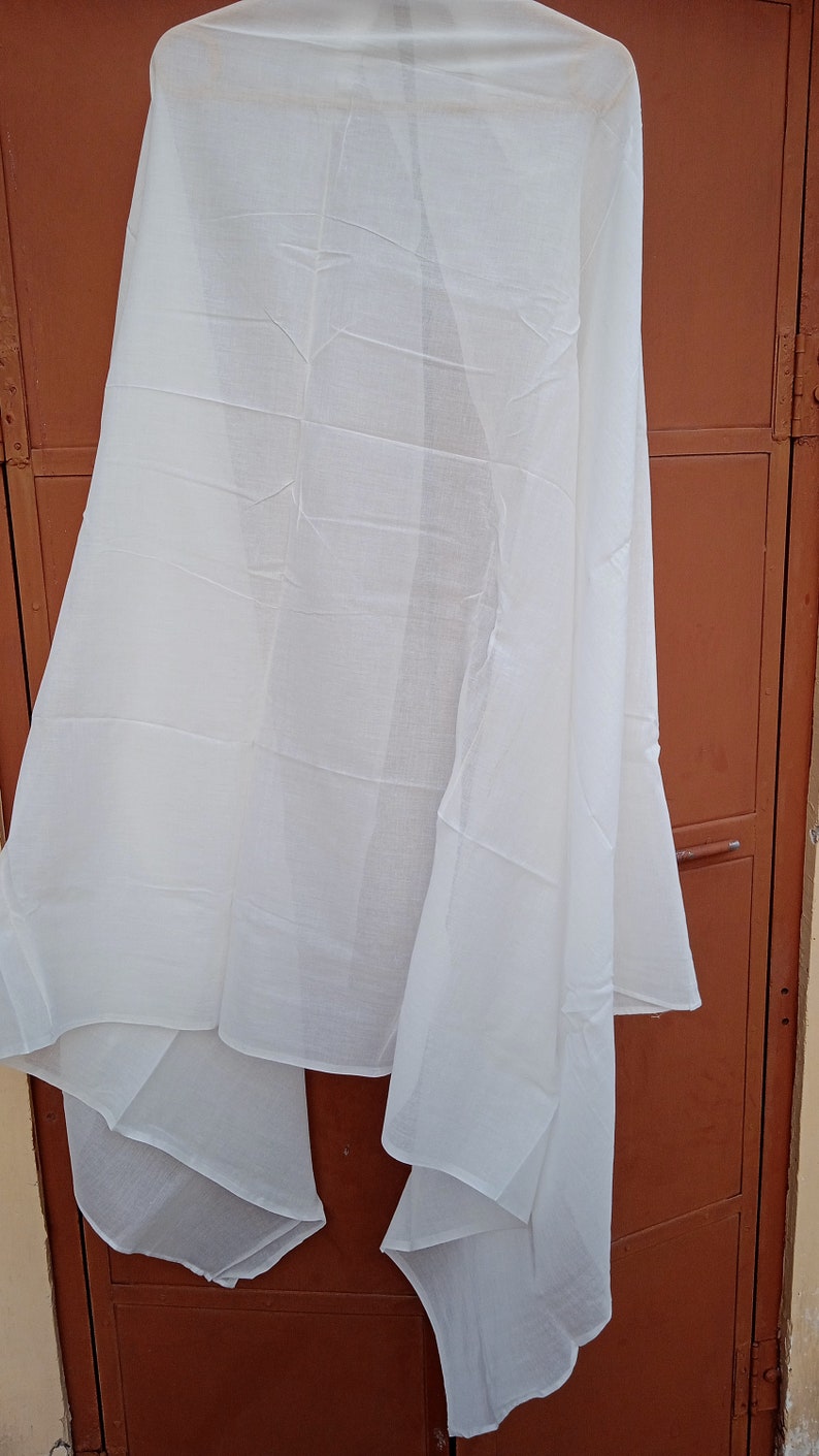 May include: A white sheer scarf, folded and draped over a brown door.