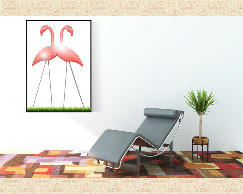 May include: A framed print of two pink flamingos standing on a grassy lawn. The print is hanging on a white wall above a gray chaise lounge. A potted plant is on the right side of the image.