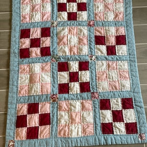 Baby quilt/crib quilt/lap quilt deep rose blue pink white hand stitched some floral squares