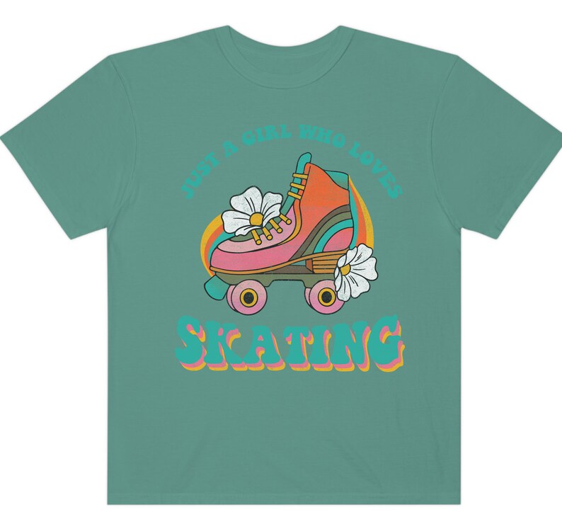 May include: Teal t-shirt with a retro graphic of a roller skate with flowers and the text "Just a girl who loves skating".