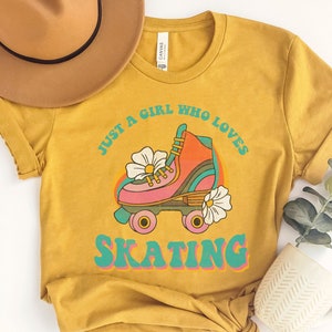 May include: A mustard yellow t-shirt with a retro graphic of a roller skate and the text "Just a girl who loves skating".